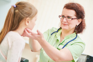 Child pediatrician. Female doctor palpating for diagnosing a disease