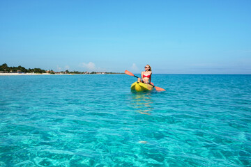 girl in the kayak in the turquoise waters