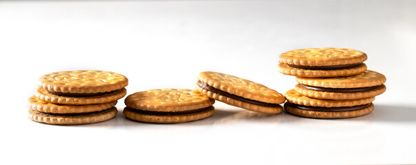 Sandwich biscuits cookies with chocolate filling on white background. Large image for banner