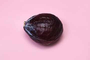 Red cabbage whole roach. On a pink background.