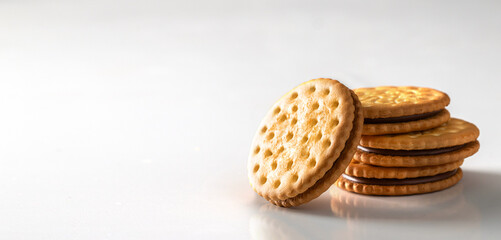 Sandwich biscuits cookies with chocolate filling on white background. Large image for banner