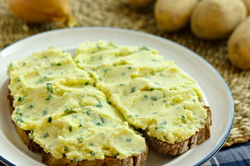 Two slices of peasant bread with German potato spread Kartoffelkäse on a plate