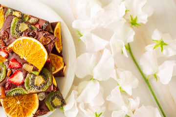 dried fruit chocolate next to white sweet peas