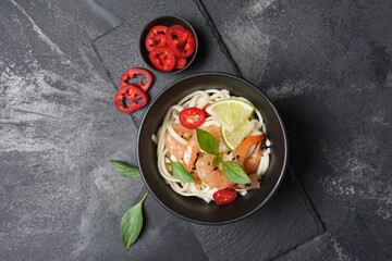 A traditional dish of Asian cuisine. Udon noodles with shrimps and red pepper