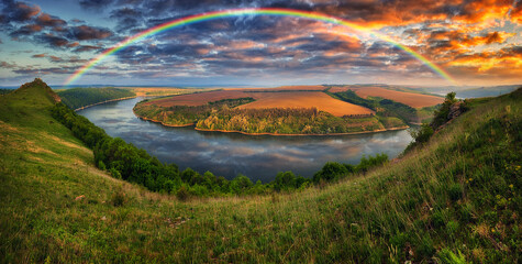 colorful rainbow over the river canyon. spring morning