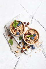 Healthy breakfast with oatmeal, berry, nuts and mint