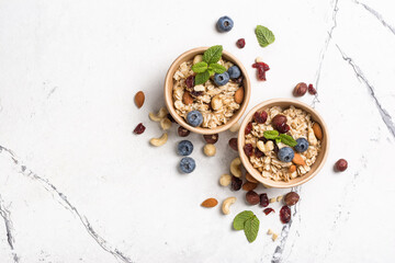 Healthy breakfast with oatmeal, berry, nuts and mint