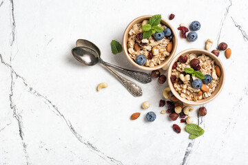 Healthy breakfast with oatmeal, berry, nuts and mint
