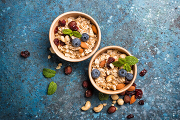 Healthy breakfast with oatmeal, berry, nuts and mint