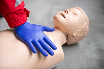 Paramedic practicing bls and cpr on a child mannequin.