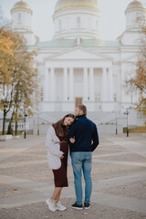 Young couple man and woman in the city landscape in the park