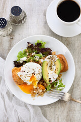 A healthy and balanced breakfast plate.
Benedict's egg spreads on a toasted toast with half an avocado, quinoa and lettuce, seasoned   spices and yogurt dressing. Enjoy the most important meal of the 