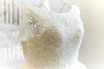 elegant wedding dress, embroidered with beads and crystals, on a mannequin hanger. details, preparation for the wedding