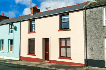 Old fashioned architecture buildings of colourful terraced town houses in Pembrokeshire Wales UK, stock photo image