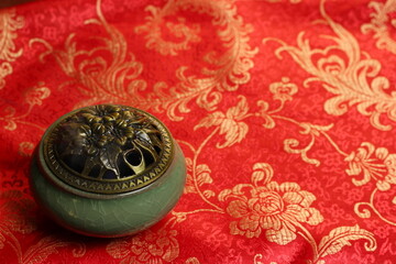 still life in Chinese style. incense burner and isolated on red background
