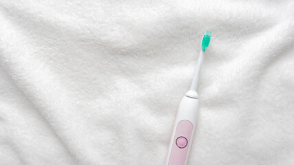 Modern rechargeable ultrasonic electric toothbrush, white background. Concept of oral care and healthy teeth by using ultrasonic smart toothbrush, 16:9