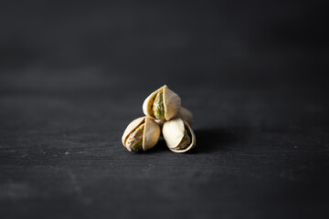pistachios isolated in the middle on, black background
