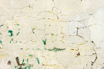 Cracked flaked shabby gray wall, old peeled white wall background