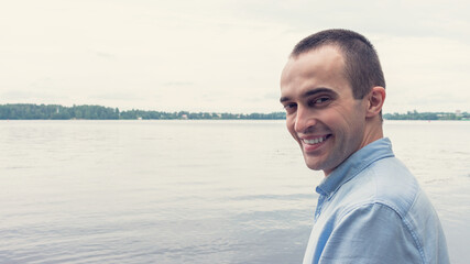 Handsome man wearing shirt at the lake, smiling guy, portrait, 16:9