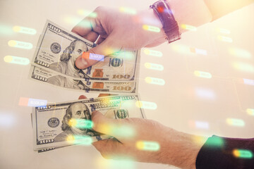 Multi exposure of technology drawing hologram and us dollars bills and man hands. Data concept