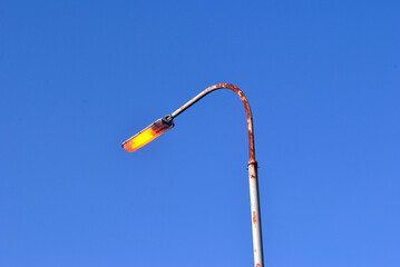 Metal Pole with Street Light against Blue Sky