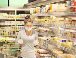 supermarket shopping, face mask and gloves,Woman choosing a dairy products at supermarket