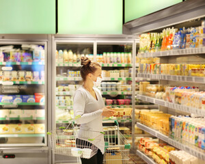 supermarket shopping, face mask and gloves,Woman choosing a dairy products at supermarket