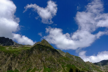 Obraz na płótnie Canvas pointed mountain with wonderful soft white clouds on the sky