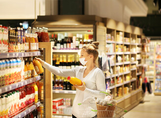 supermarket shopping, face mask and gloves,Woman choosing a dairy products at supermarket