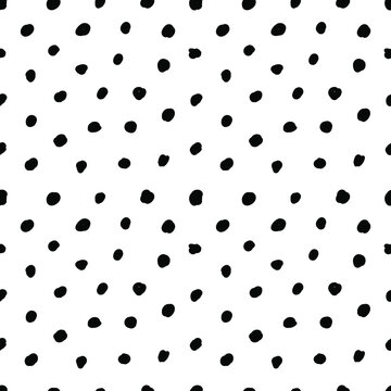 Abstract seamless pattern of black polka dots on white background