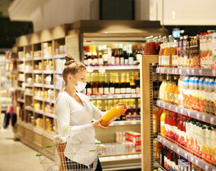 supermarket shopping, face mask and gloves,Woman choosing a dairy products at supermarket