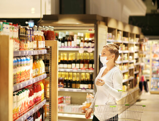 supermarket shopping, face mask and gloves,Woman choosing a dairy products at supermarket