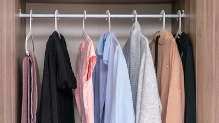 Concept of clothes and closet. Clothes rack with clothes, close up, 16:9