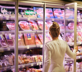 Woman choosing a dairy products at supermarket.