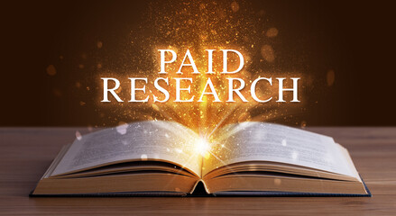 PAID RESEARCH inscription coming out from an open book, educational concept