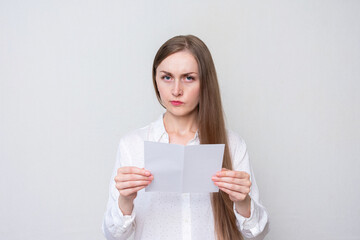 Fototapeta na wymiar Dissatisfied woman reading a letter, white background