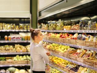 Woman buying fruits and vegetables at the market.