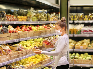Supermarket shopping, face mask and gloves,Woman buying fruits at the market.