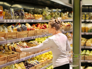 Woman buying fruits and vegetables at the market.