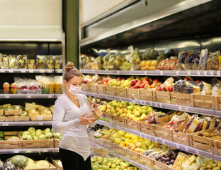 Supermarket shopping, face mask and gloves,Woman buying fruits at the market.
