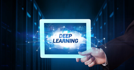 Young business person working on tablet and shows the inscription: DEEP LEARNING