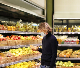 Supermarket shopping, face mask and gloves,man buying vegetables at the market.