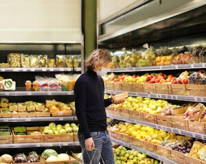 Supermarket shopping, face mask and gloves,man buying vegetables at the market.