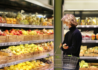Supermarket shopping, face mask and gloves,man buying vegetables at the market.