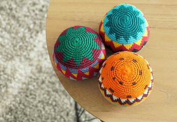 Close up of three colorful different juggling balls on a round table