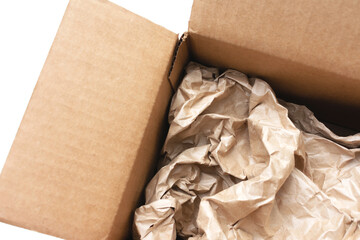 Cardboard box, crumpled yellow craft paper, white background, top view, cropped image, closeup