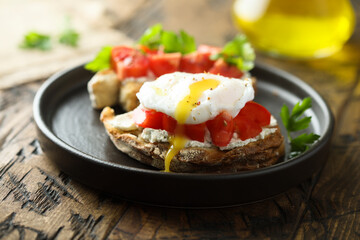Homemade toast with tomato and poached egg