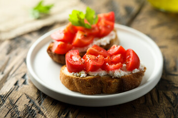 Homemade bruschetta with cream cheese and tomato