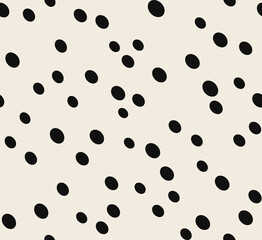 Seamless pattern of thabstract animal background. Hand-drawn trendy cheetah pattern isolated on a beige background. Suitable for web and print design. The asymmetr texture of different sizes of ovals.