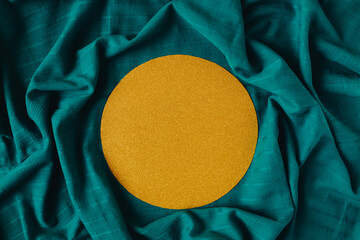 Sunny gold round with glitter effect on the dark cyan background. Summer warm concept.